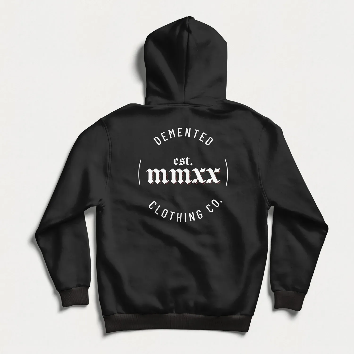 The back of a black Demented hoodie with the round seal